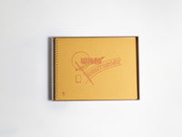 Yellow sketchbook with a logo on a white background
