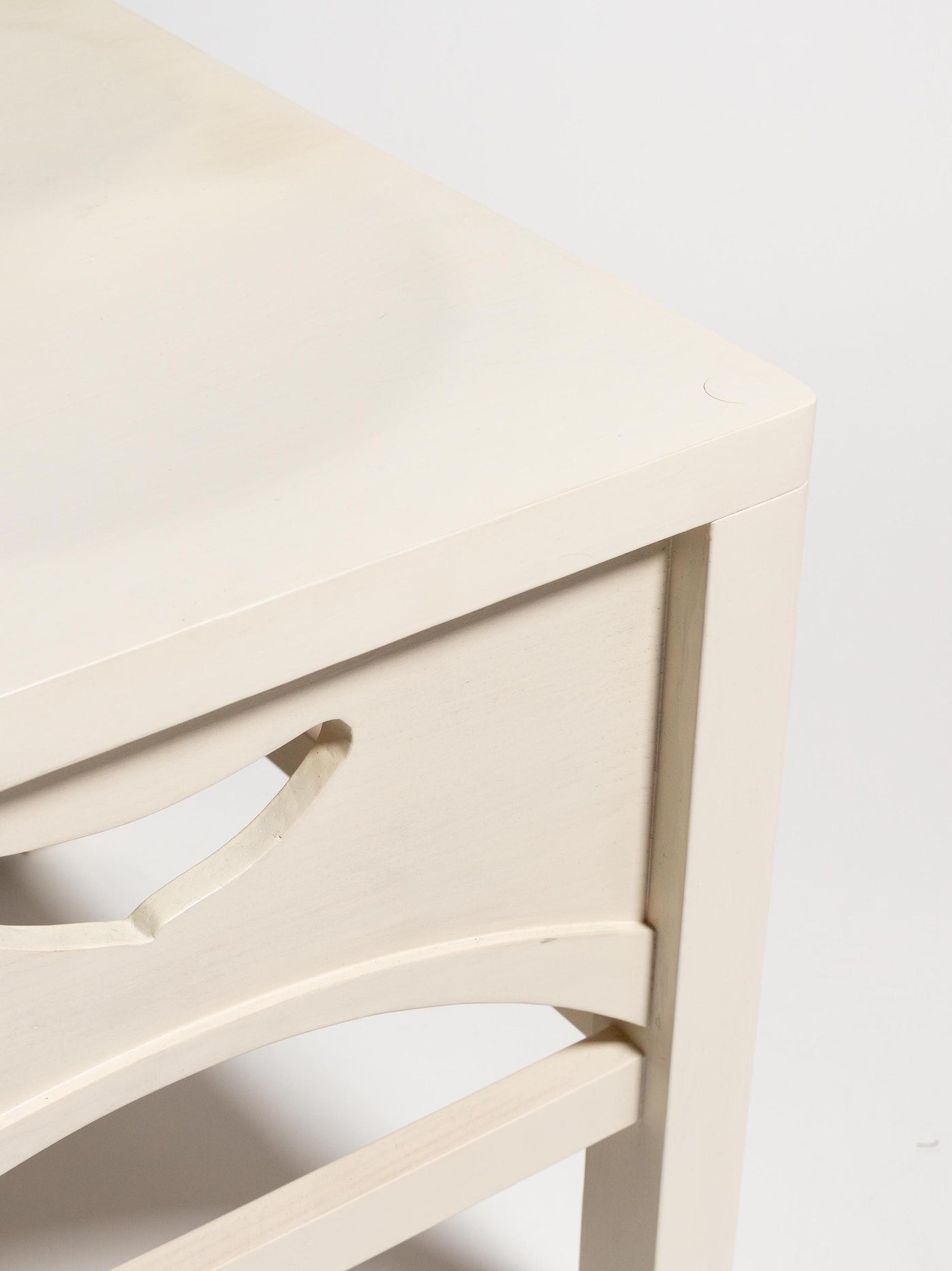 Close-up of a light wood chair with a white background