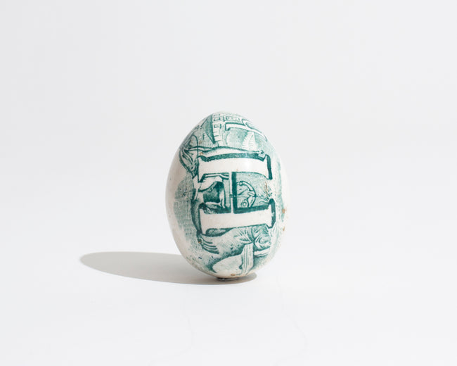 19TH CENTURY TRANSFER DECORATED POTTERY DARNING EGG IN GREEN WITH HAND-PAINTED 'H' MOTIF [1830]