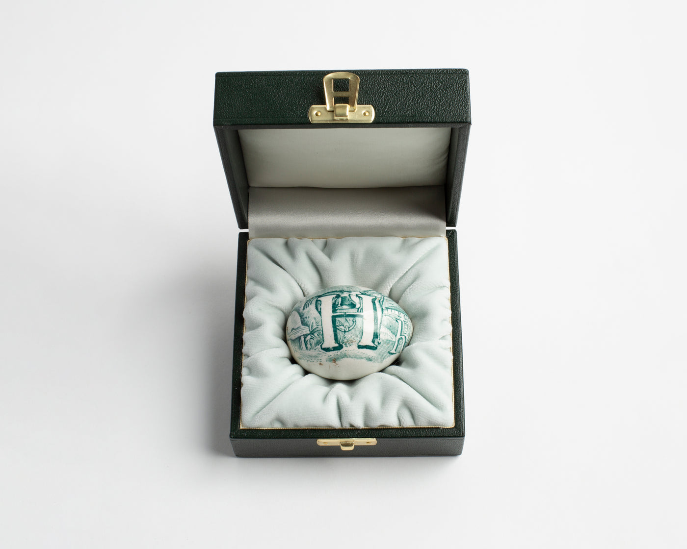 19TH CENTURY TRANSFER DECORATED POTTERY DARNING EGG IN GREEN WITH HAND-PAINTED 'H' MOTIF [1830]