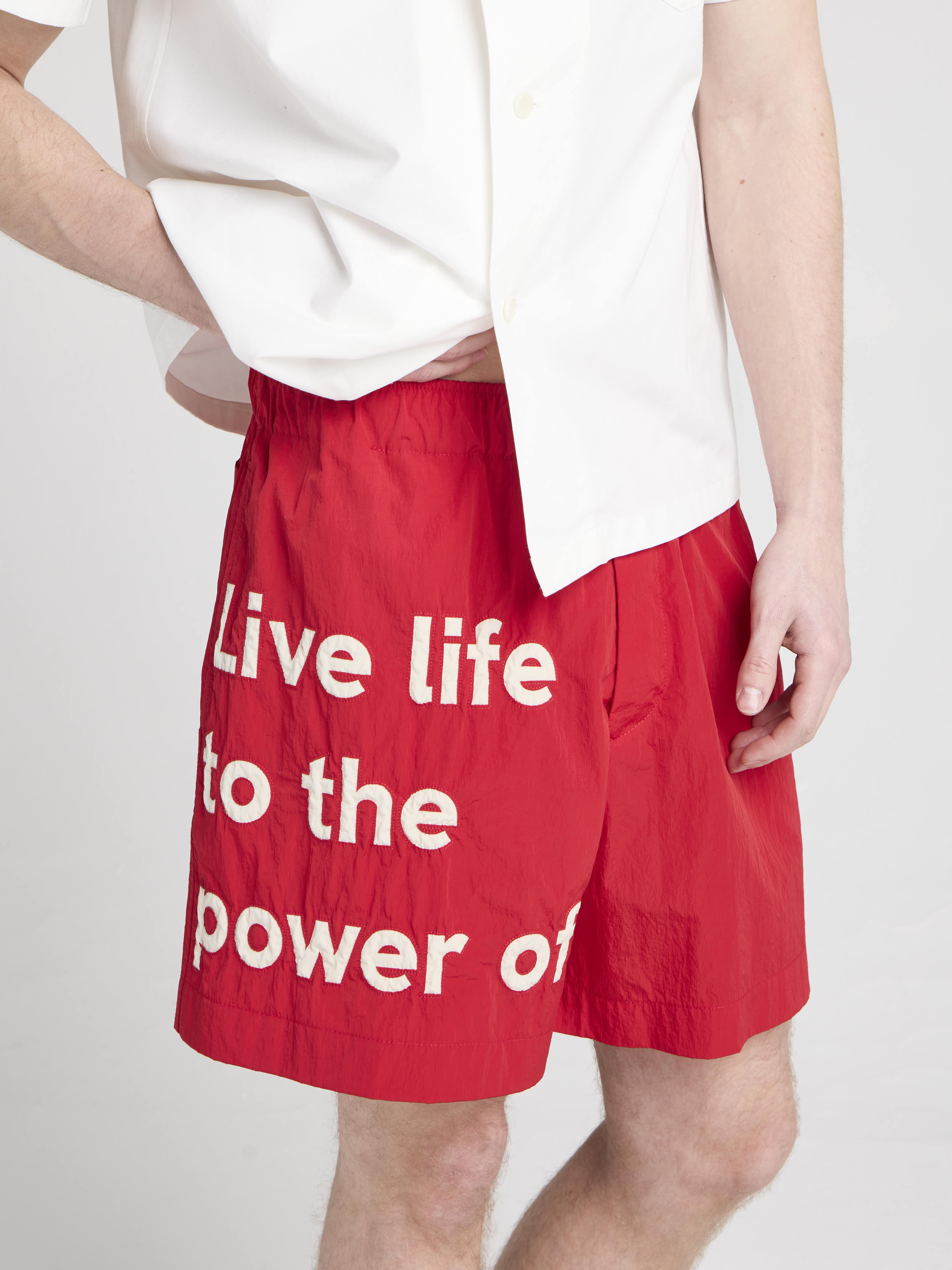 Unisex JW ANDERSON X GUINNESS SLOGAN TRACK SHORTS IN RED in RED